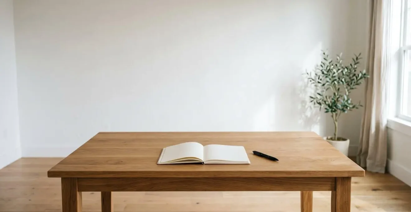 A minimalist scene of a blank, open notebook on a wooden table, representing the need for a dynamic and constantly reviewed care plan.